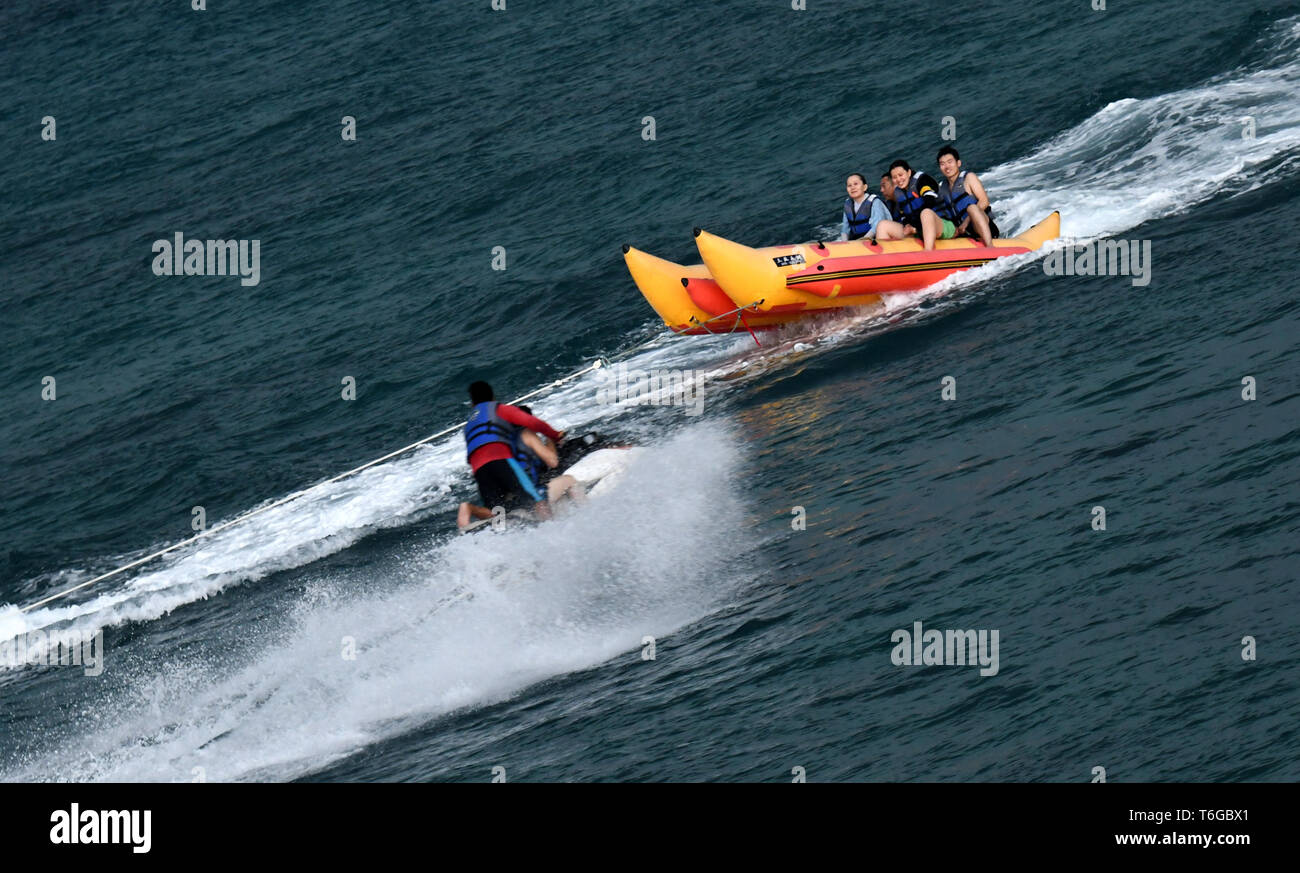 (190501) -- LINGSHUI, May 1, 2019 (Xinhua) -- Tourists take part in an aquatic activity in the Boundary Island scenic area in Lingshui Li Autonomous County, south China's Hainan Province, May 1, 2019 Tourism boosts as many people go out for recreational activities during China's four-day Labor Day national holiday. (Xinhua/Zhao Yingquan) Stock Photo