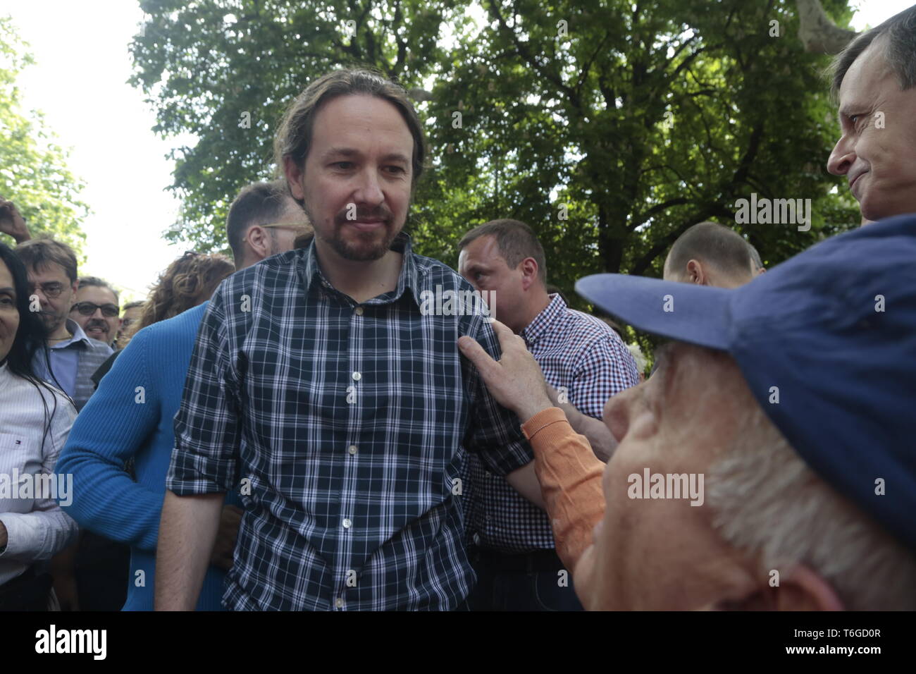 Madrid, Spain. 1st May, 2019. Pablo Iglesias, leader and congressman of Podemos seen speaking with a protester during the demonstration.Thousands of protesters demonstrate on the International Workers' Day convoked by the majority unions UGT and CCOO to demand policies and reductions in unemployment levels in Spain, against job insecurity and labour rights. Politicians of the PSOE and Podemos have participated in the demonstration. Credit: Lito Lizana/SOPA Images/ZUMA Wire/Alamy Live News Stock Photo