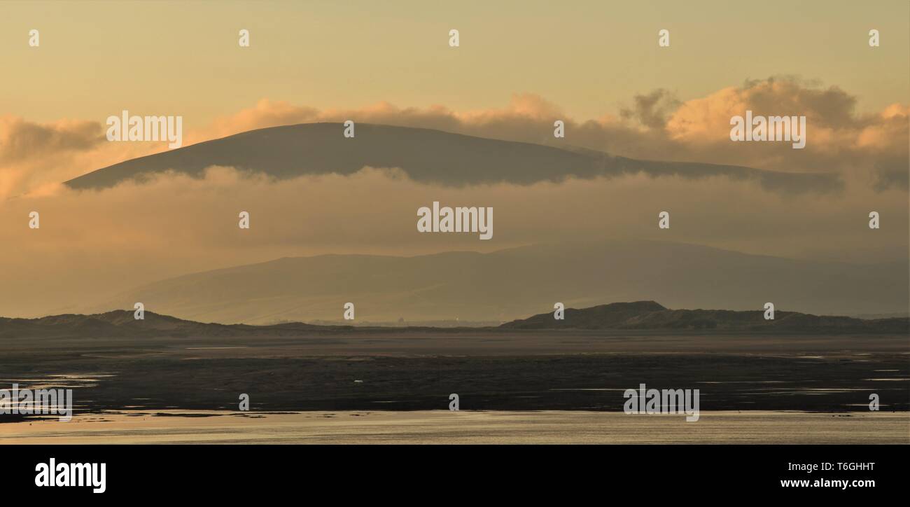 Barrow-In-Furness, Cumbria, UK. 1st May 2019. UK Weather. After a day of sunshine and showers from the Cumbrian Coast. View across Walney Channel towards Black Combe and the English Lake District. Credit : greenburn / Alamy Live News. Stock Photo