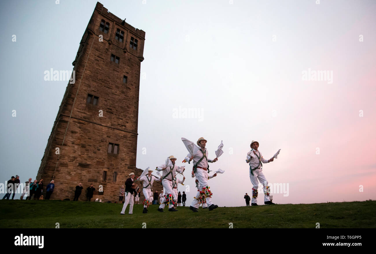 The White Rose Morris Men during their 'Dance in the Dawn' to mark May Day, or Beltane as it was once known, at first light on Castle Hill in Huddersfield, West Yorkshire. Stock Photo