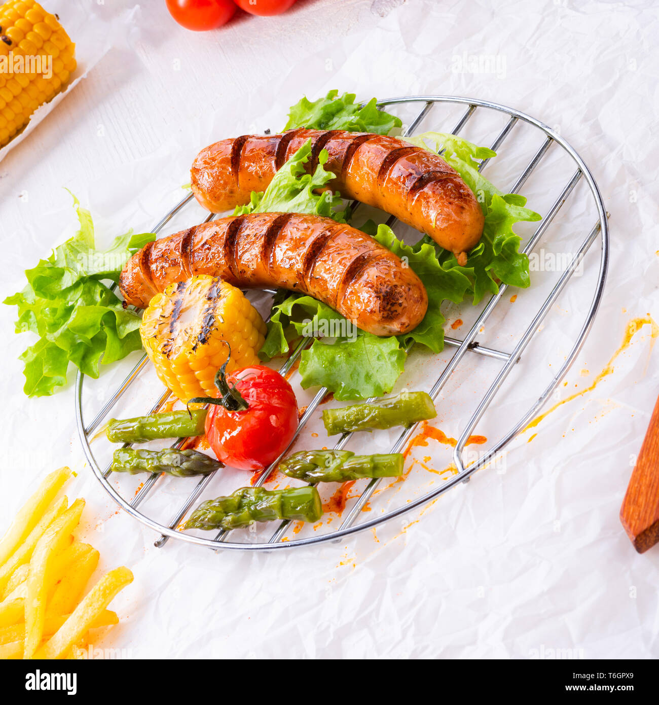 grilled krakauer sausage with boiled corn and green salad Stock Photo -  Alamy
