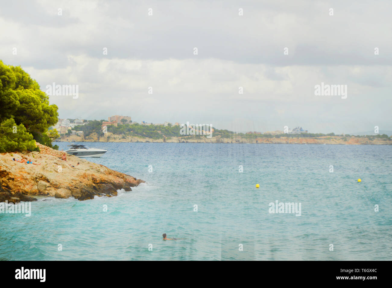 Majorca Rays Sun's rays Shine through the clouds over the turquoise sea on the beach ...