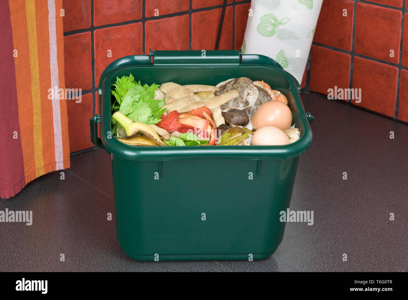 Food waste for composting in domestic recycling waste bin Stock Photo