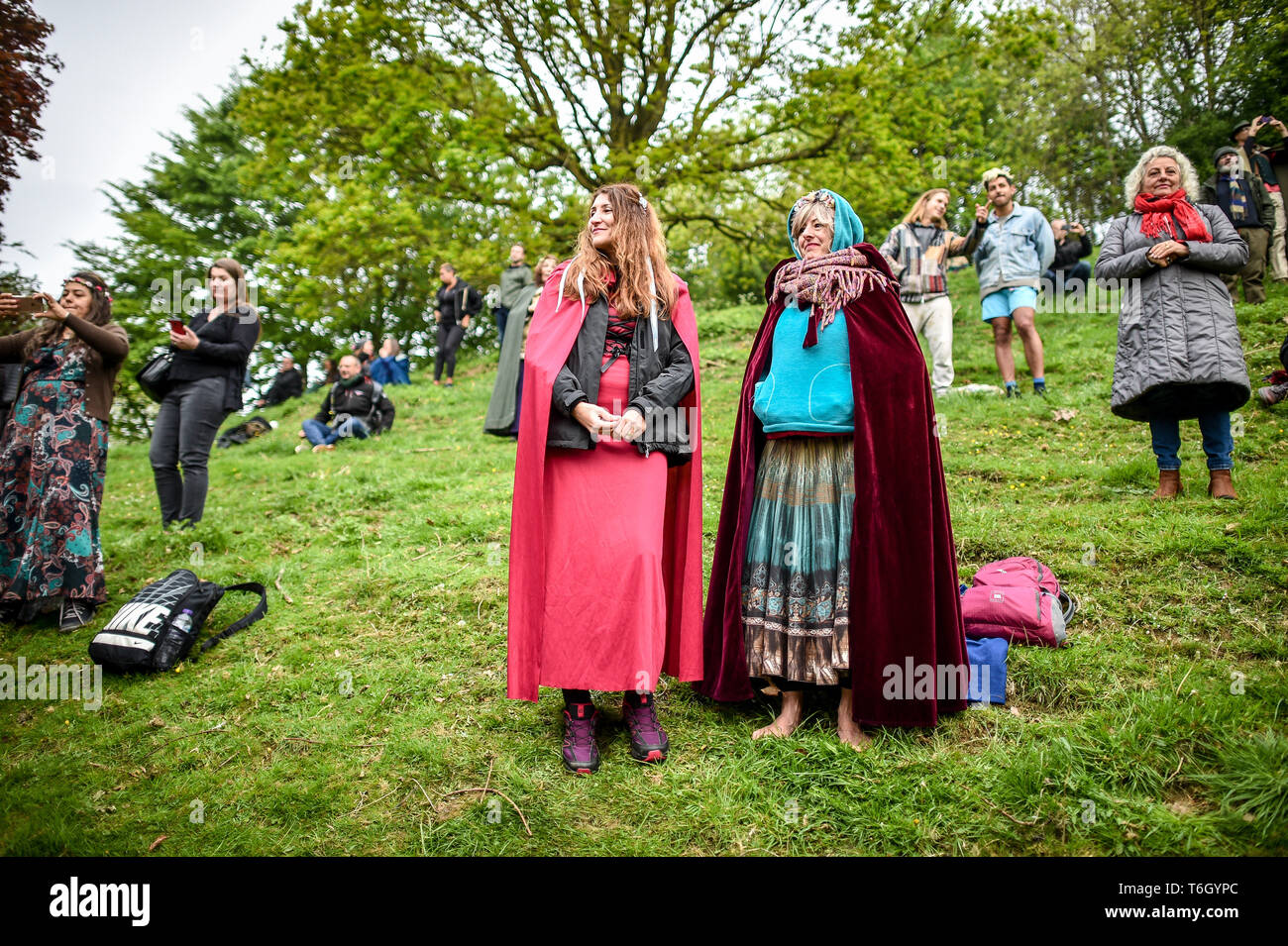 People dress in robes during the Beltane celebrations at Glastonbury Chalice Well, where people gather to observe a modern interpretation of the ancient Celtic pagan fertility rite of Spring. Stock Photo