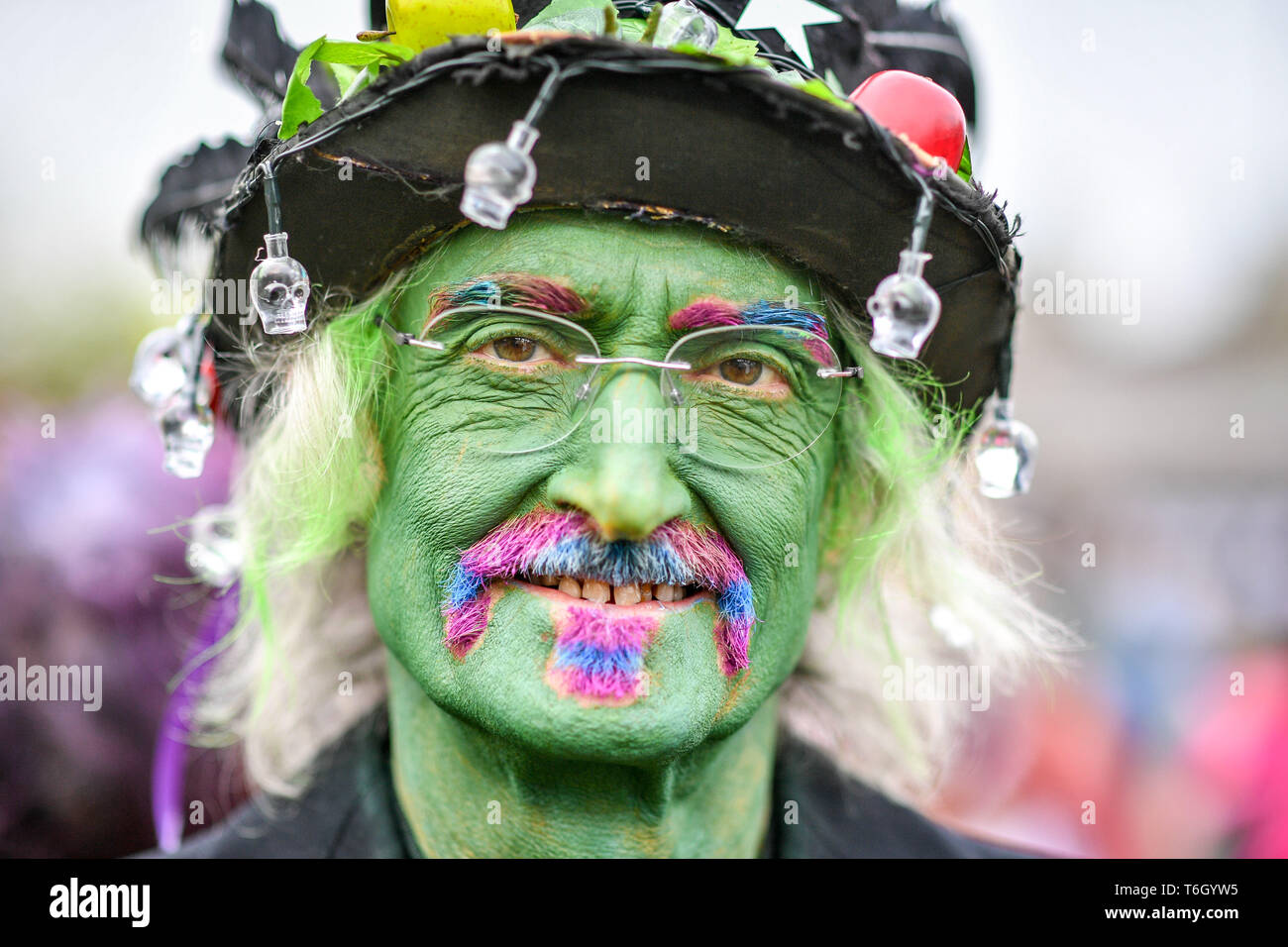 Glastonbury Border Morris Edwin Growney wears green face paint during the Beltane celebrations at Glastonbury Chalice Well, where people gather to observe a modern interpretation of the ancient Celtic pagan fertility rite of Spring. Stock Photo