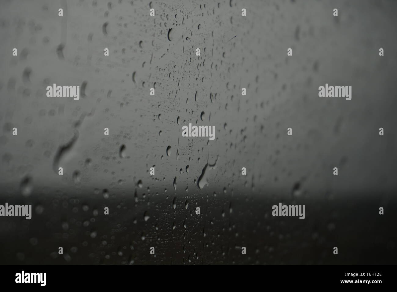 Raindrops from the inside of a train window Stock Photo