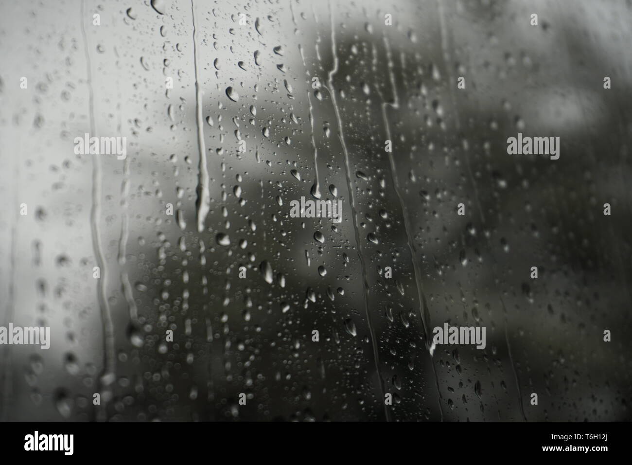 Raindrops from the inside of a train window Stock Photo