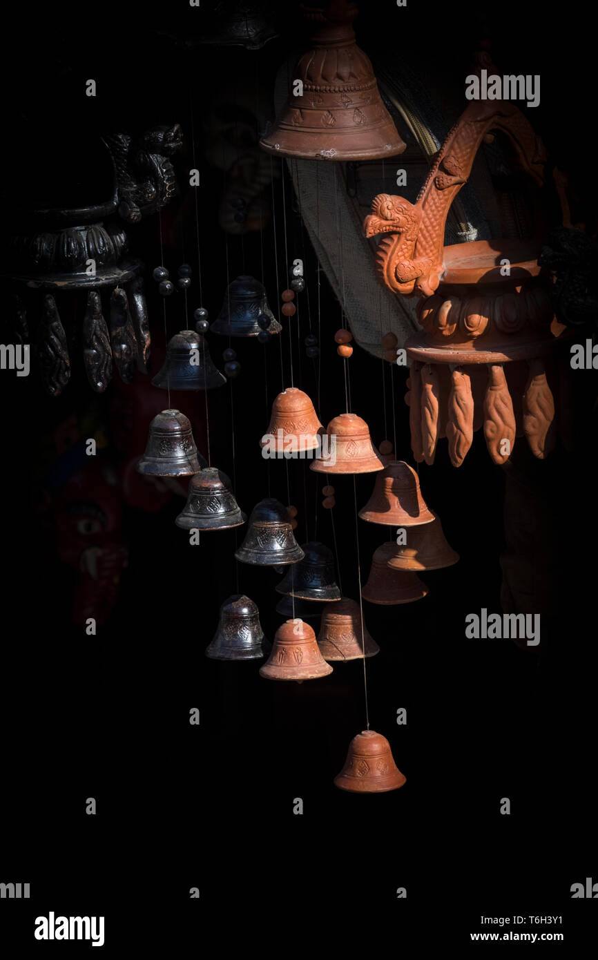 Beautiful small Clay hanging bells with Black background on street market Bandipur Nepal Stock Photo