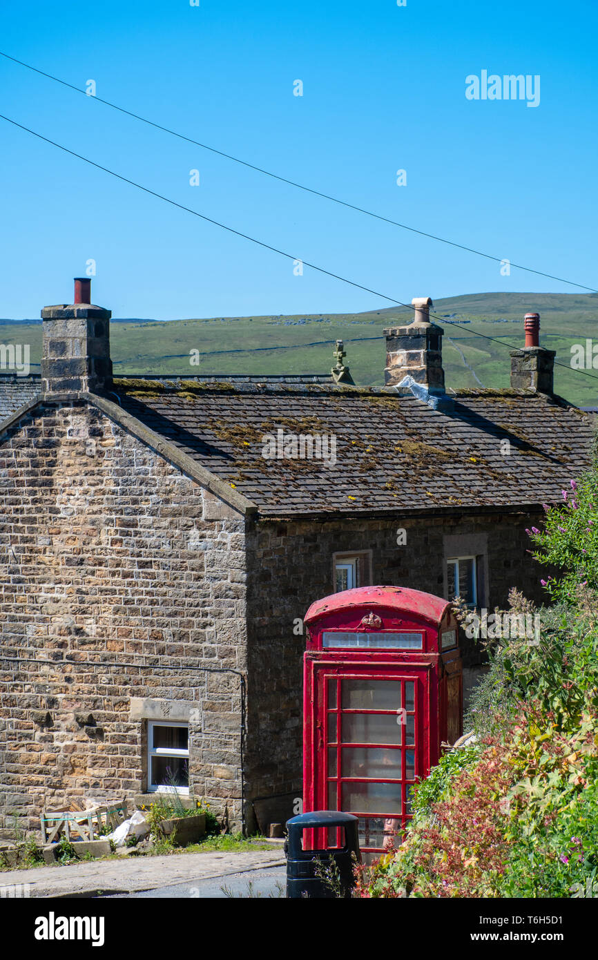 Traditional Red Phone box and cottage Stock Photo
