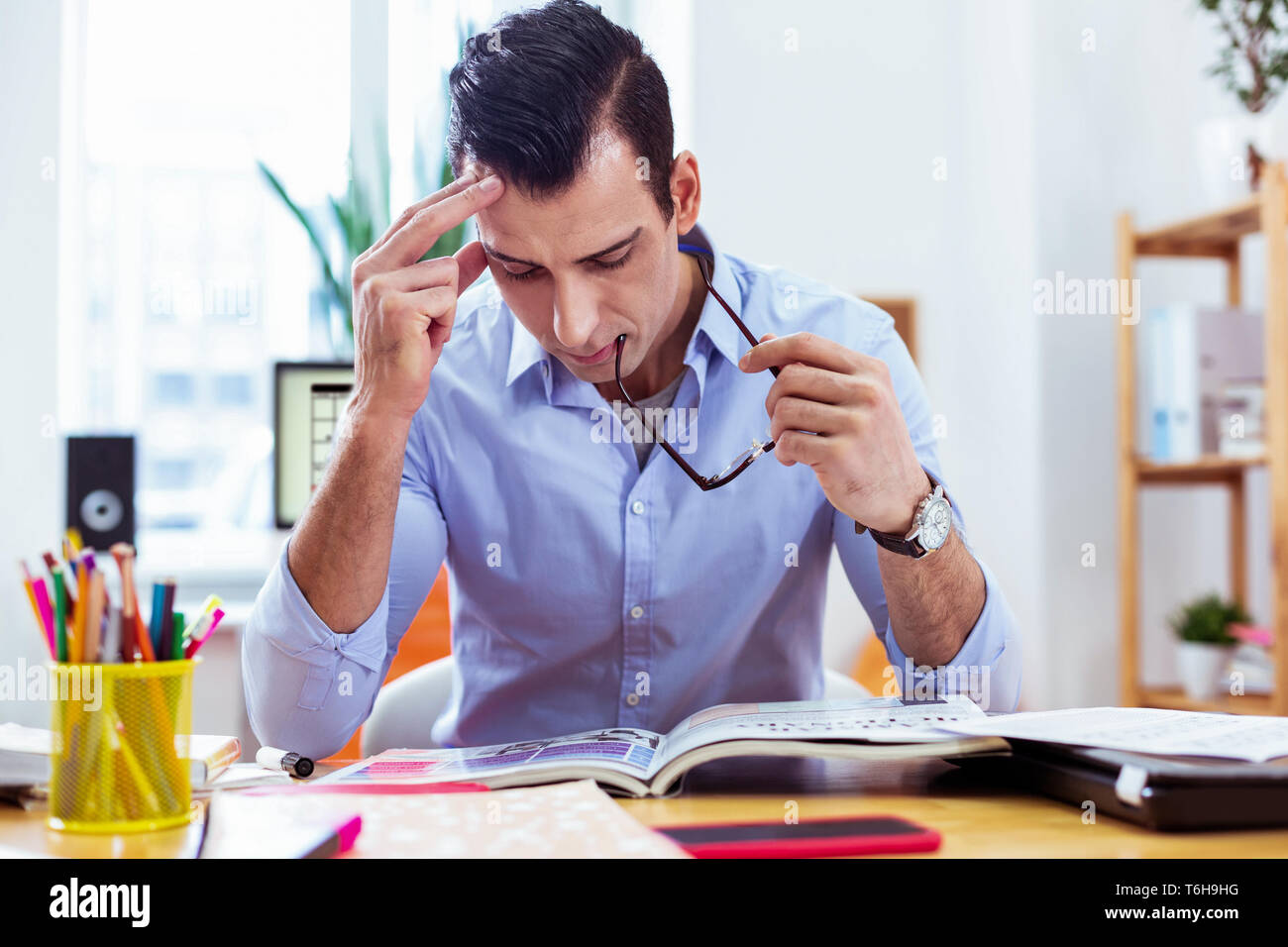 Nice serious man looking into the book Stock Photo
