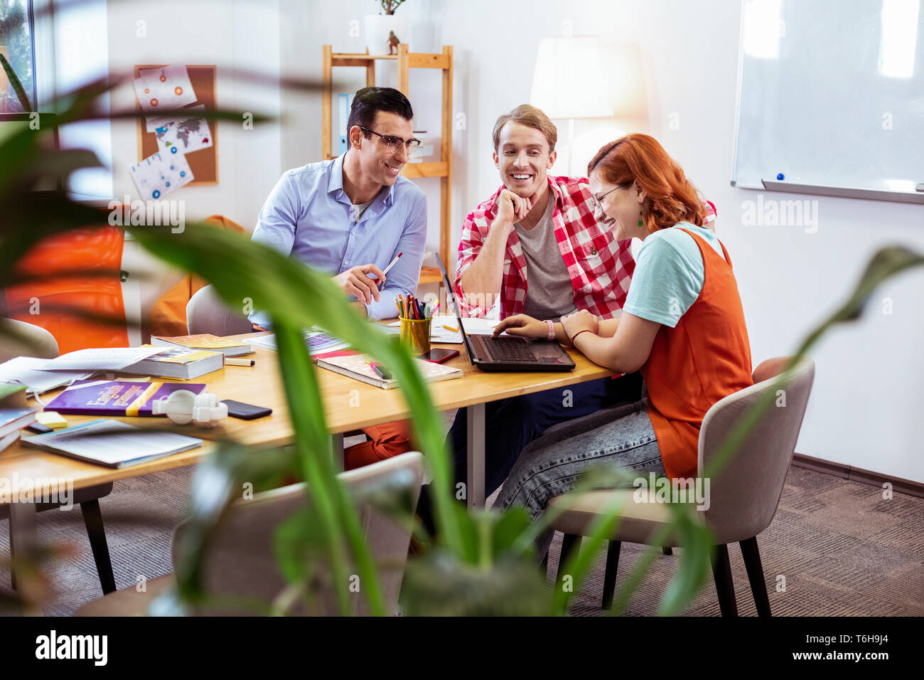 Joyful young people working together in team Stock Photo