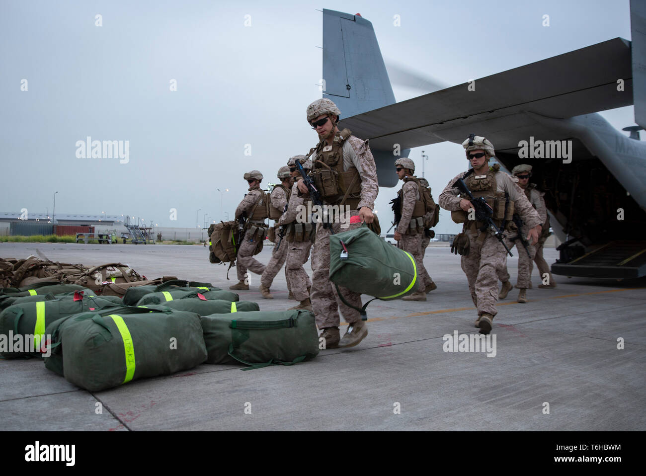 U.S. Marines with Counter-Unmanned Aerial Systems Detachment, 2nd Low Altitude Air Defense Battalion, attached to Special Purpose Marine Air Ground Task Force Crisis Response-Central Command, unload gear after arriving in Southwest Asia, April 15, 2019. 2nd LAAD Battalion provides close in, low altitude, surface-to-air weapons fires in defense of forward combat areas and installations in the Central Command area of operations. (U.S. Marine Corps photo by Cpl. Alina Thackray) Stock Photo