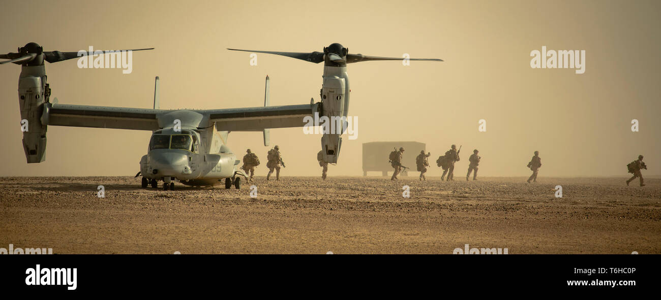 U.S. Marines with Charlie Company, 1st Battalion, 7th Marines, attached to Special Purpose Marine Air Ground Task Force Crisis Response-Central Command, disembark an MV-22 Osprey during a tactical recovery of aircraft and personnel exercise at Camp Buehring, Kuwait, April 28, 2019. The SPMAGTF-CR-CC is a multiple force provider designed to employ ground, logistics and air capabilities throughout the Central Command area of responsibility. (U.S. Marine Corps photo by Sgt. Justin Huffty) Stock Photo