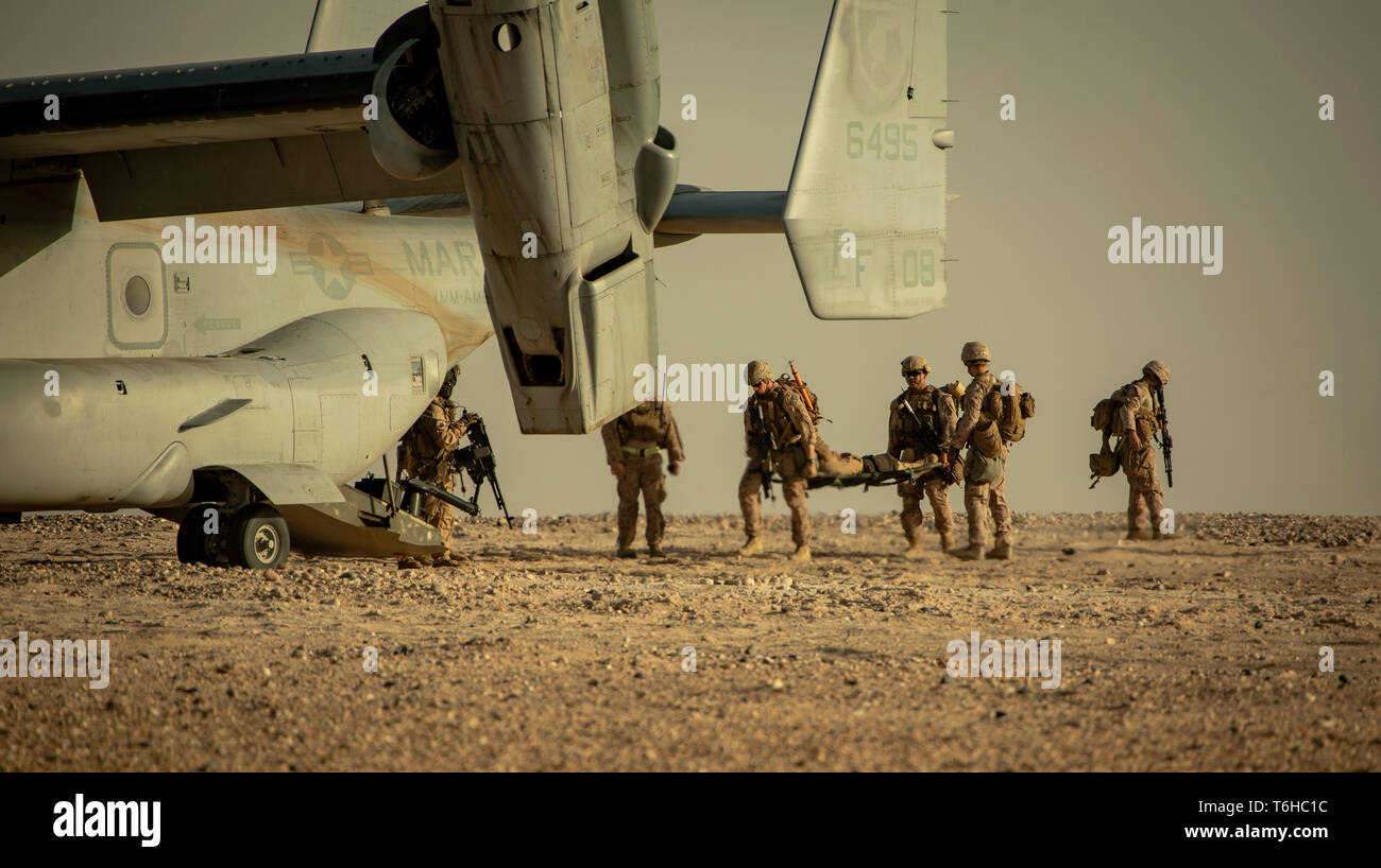 U.S. Marines with Charlie Company, 1st Battalion, 7th Marines, attached to Special Purpose Marine Air Ground Task Force Crisis Response-Central Command, load a simulated casualty onto an MV-22 Osprey during a tactical recovery of aircraft and personnel exercise at Camp Buehring, Kuwait, April 28, 2019. The SPMAGTF-CR-CC is a multiple force provider designed to employ ground, logistics and air capabilities throughout the Central Command area of responsibility. (U.S. Marine Corps photo by Sgt. Justin Huffty) Stock Photo