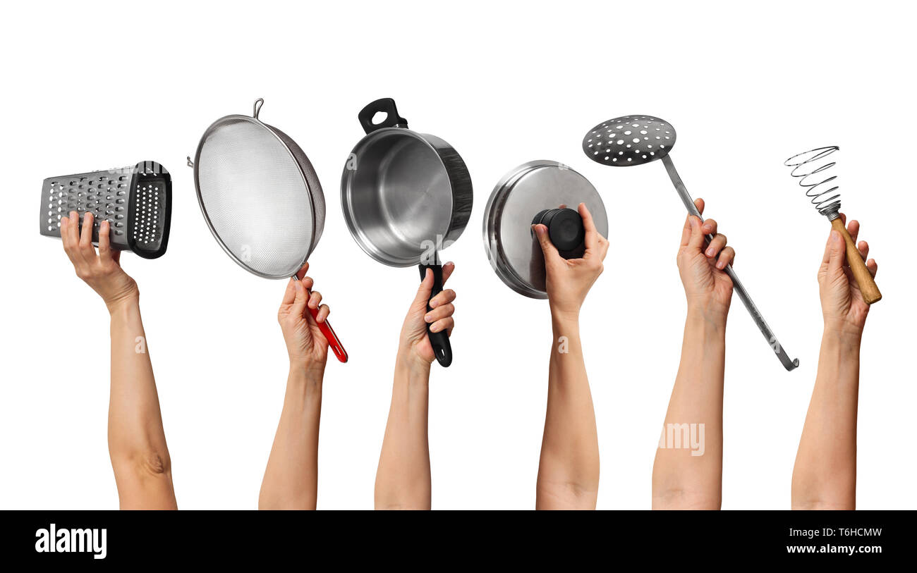 set of the metal kitchen equipment in hands, on white background Stock Photo