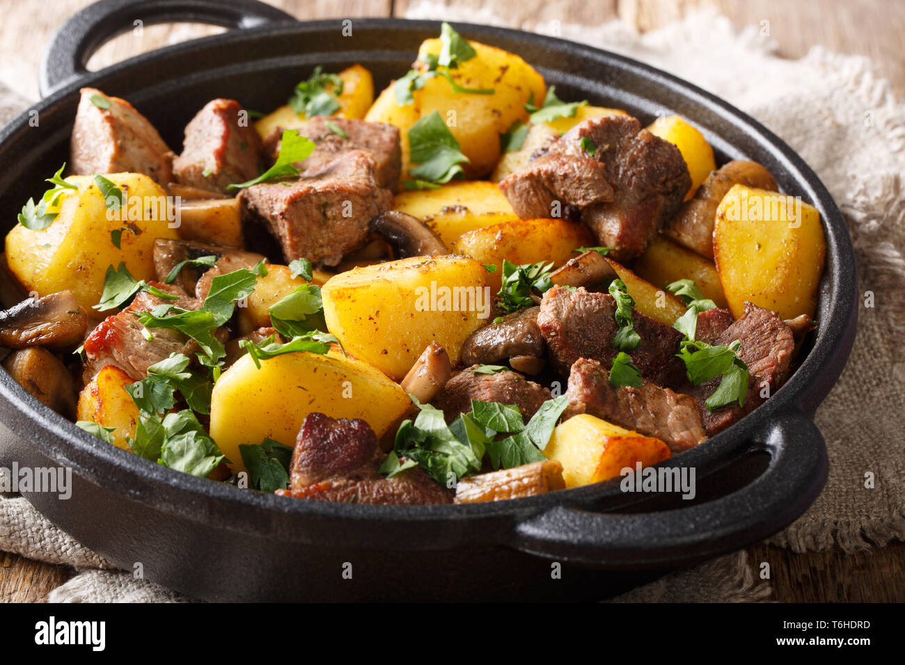 Fried Potatoes With Meat And Mushrooms Close Up On The Table Rustic Style Horizontal Stock Photo Alamy