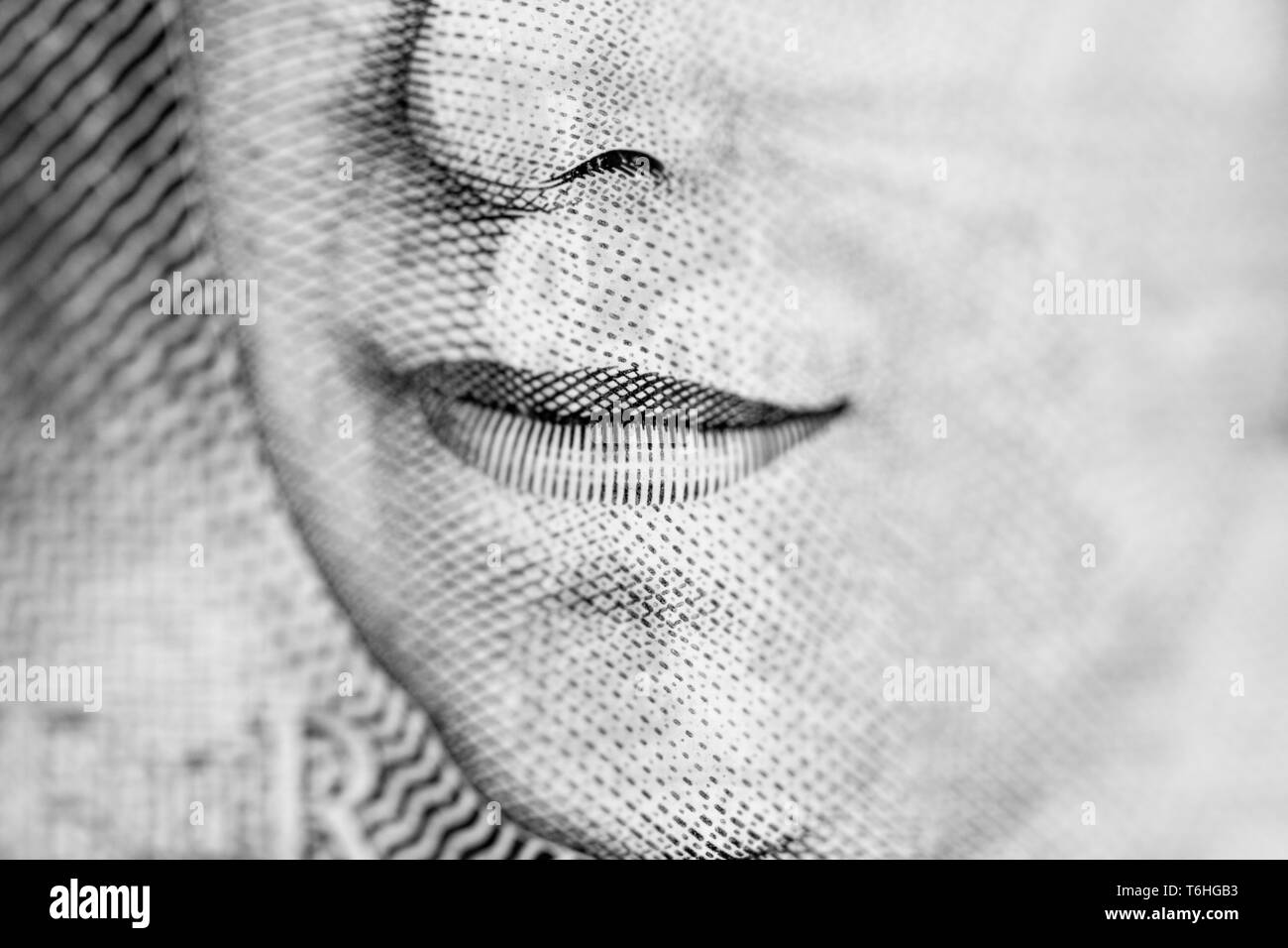 Close-up, macro photo of a piece of £10 banknote. Ten pounds sterling. Portrait of Queen Elizabeth II, mouth. Stock Photo