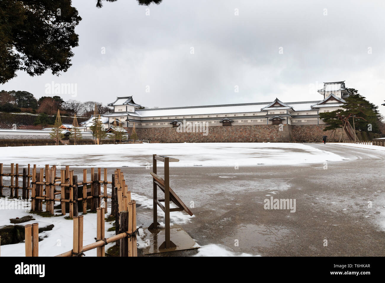 The Gojukken Nagaya, a tamon yagura, and Hashizume-mon Tsuzuki Yagura, gate and turret, Kanazawa castle, after snowfall. Dark grey clouds. Stock Photo