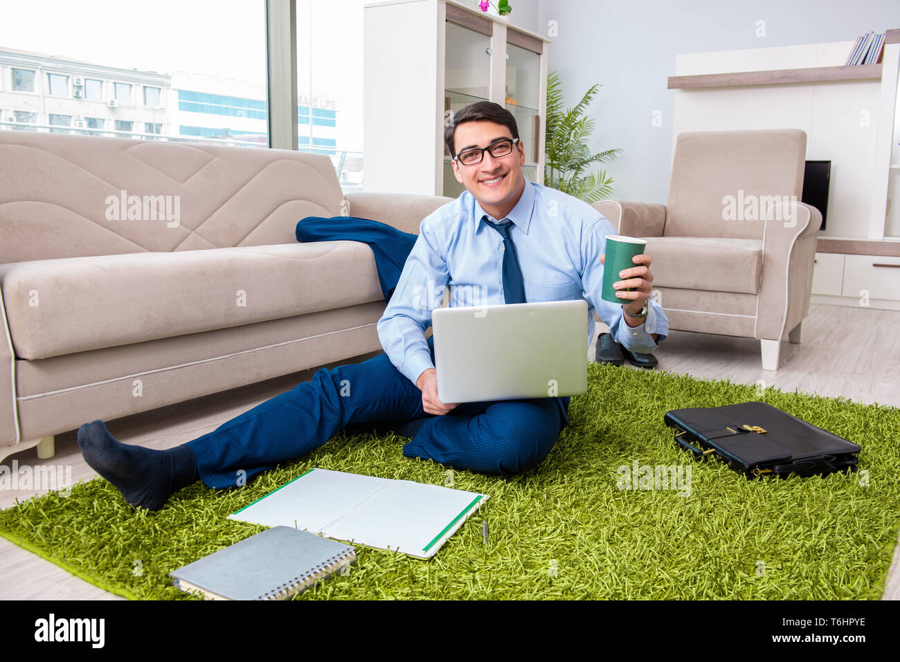 Businessman taking work home and working overtime Stock Photo