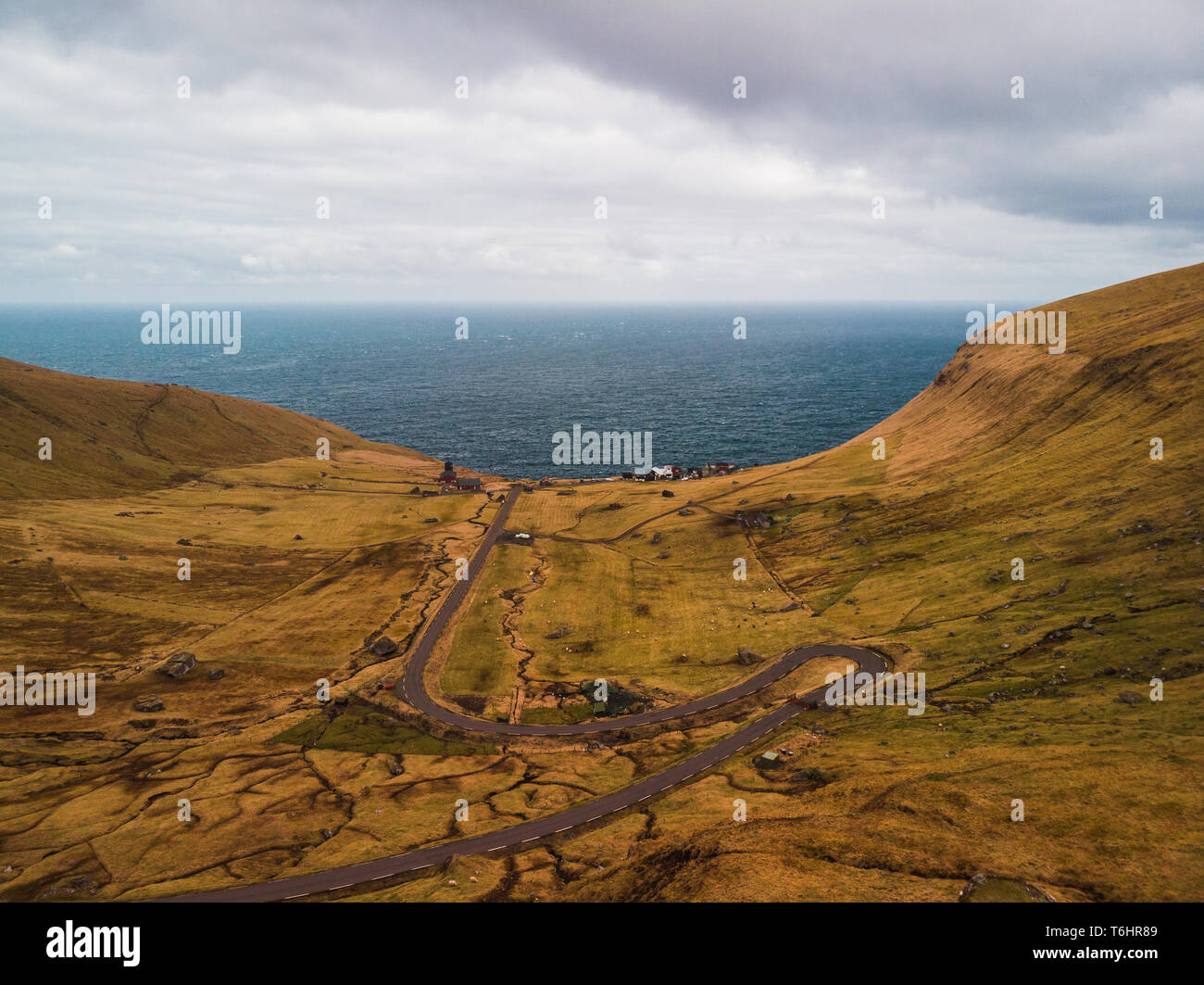 Aerial view of the small village Trøllanes on Kalsoy island with the turquoise Atlantic ocean as background (Faroe Islands, Denmark, Europe) Stock Photo