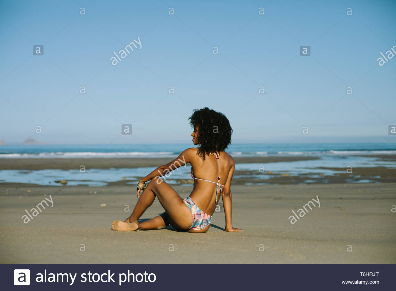 Young Beautiful Black Woman Relaxing Towards The Sea On Summer