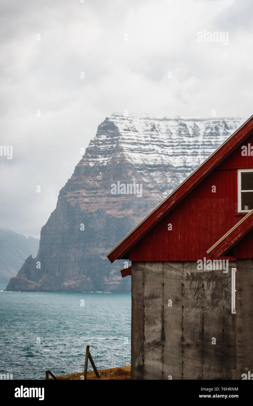 View onto the high mountains of Kunoy islands as seen from the small village of Trøllanes near Kallur lighthouse on Kalsoy island (Faroe Islands) Stock Photo