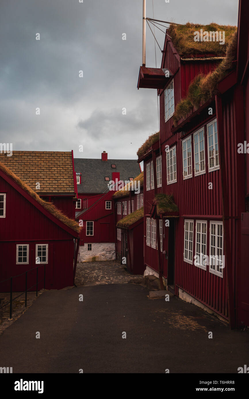 Typical red wooden houses with moss-covered roofs in the centre of Tórshavn near the harbour (Faroe Islands, Denmark, Europe) Stock Photo