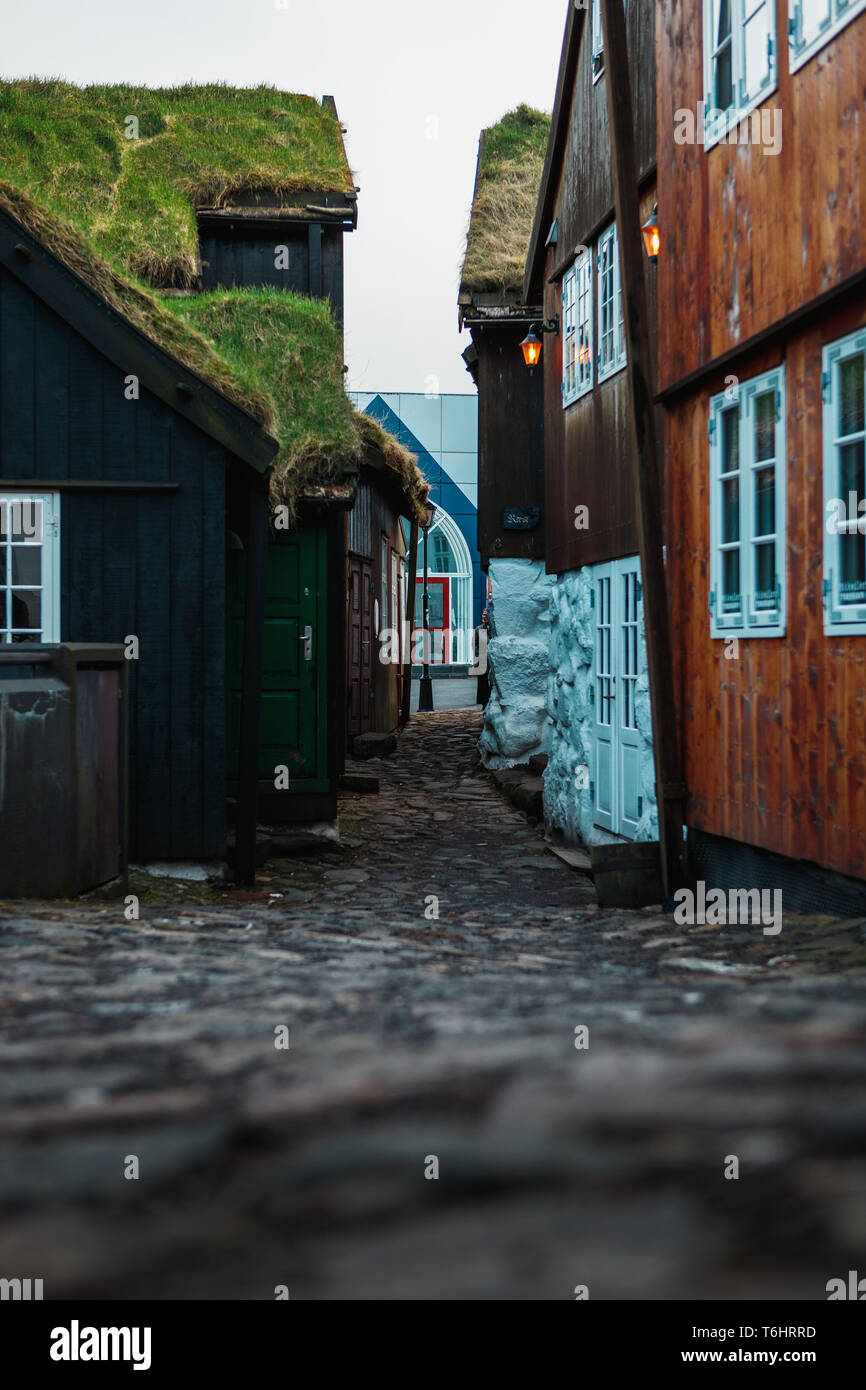 Small alley in the centre of Tórshavn (capital of Faroe Islands) with typical black and red wooden houses with moss-covered roofs (Faroe Islands) Stock Photo