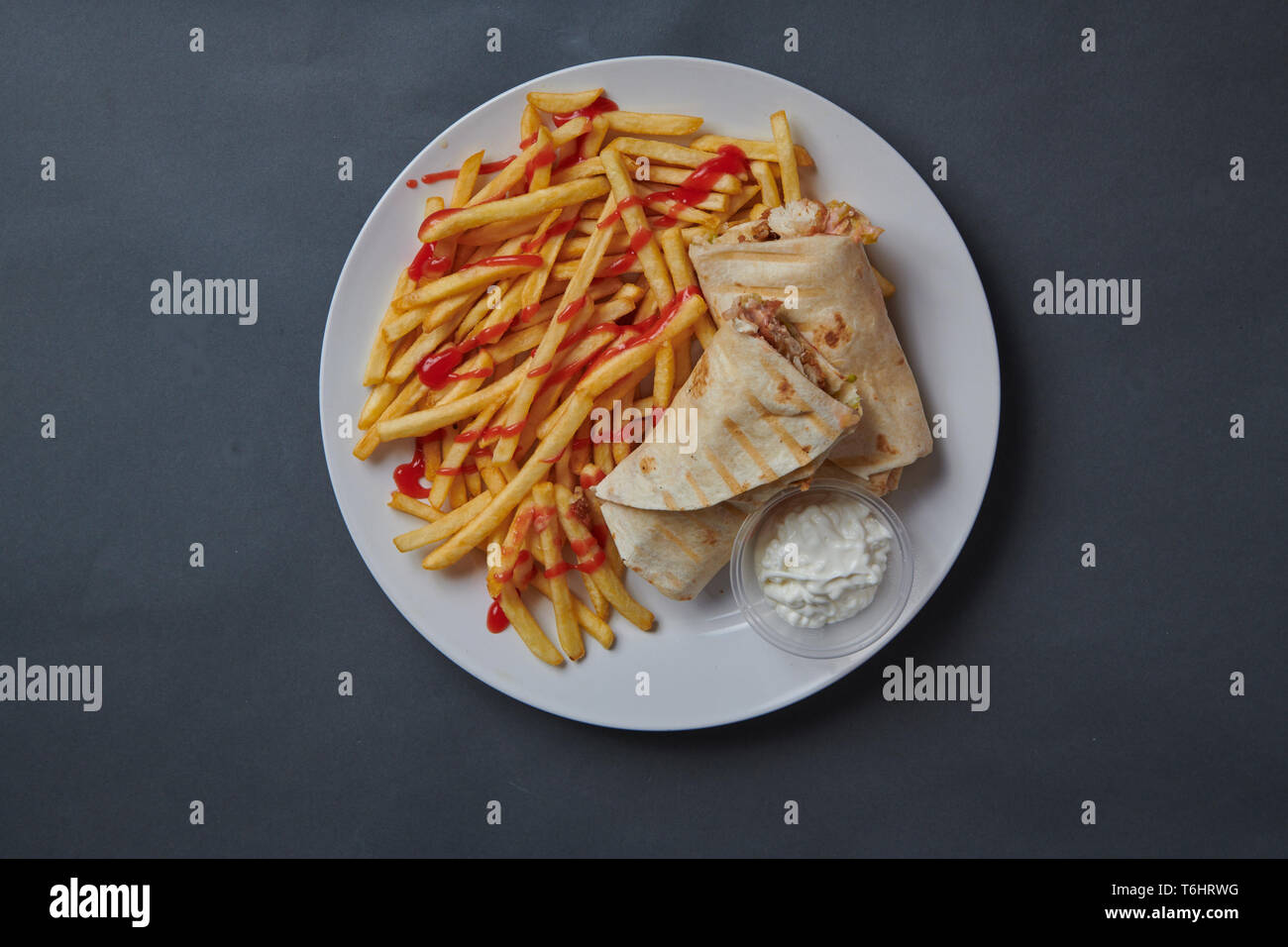 Chicken Kebab and chips on a grey background Stock Photo
