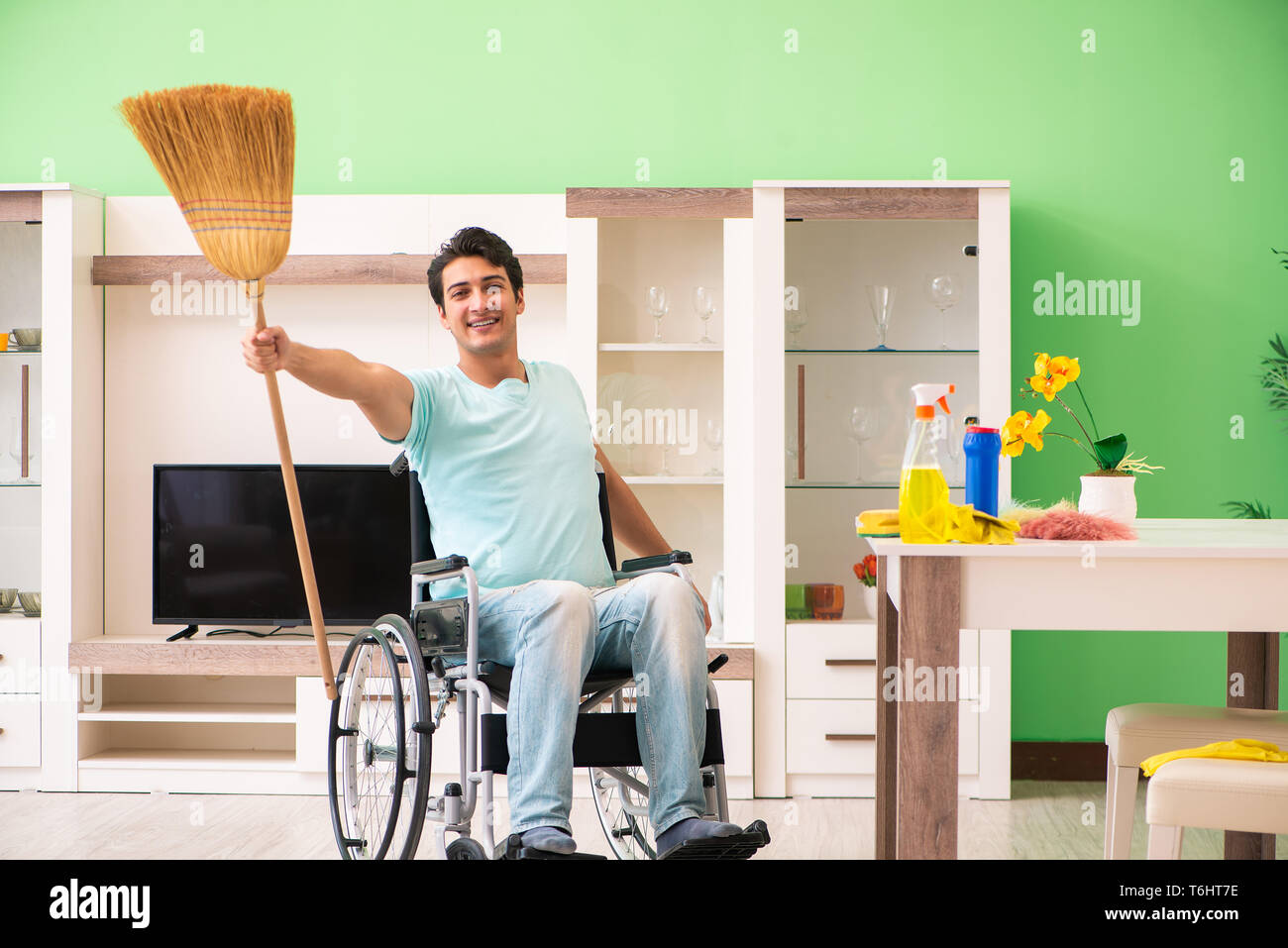 Disabled man on wheelchair cleaning house Stock Photo Alamy