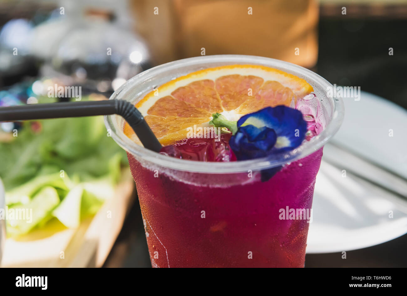 Ice cold sweet berry fruit drink  with outdoor sunset lighting. Stock Photo