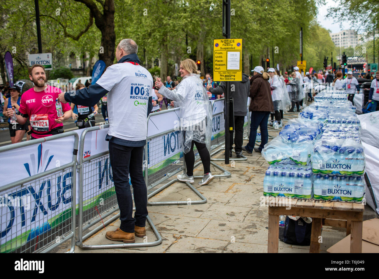 Water station at the London Marathon 2019 serving Buxton water bottles. Plastic bottles. Plastic bottle. Refreshment station for runners. Packs Stock Photo