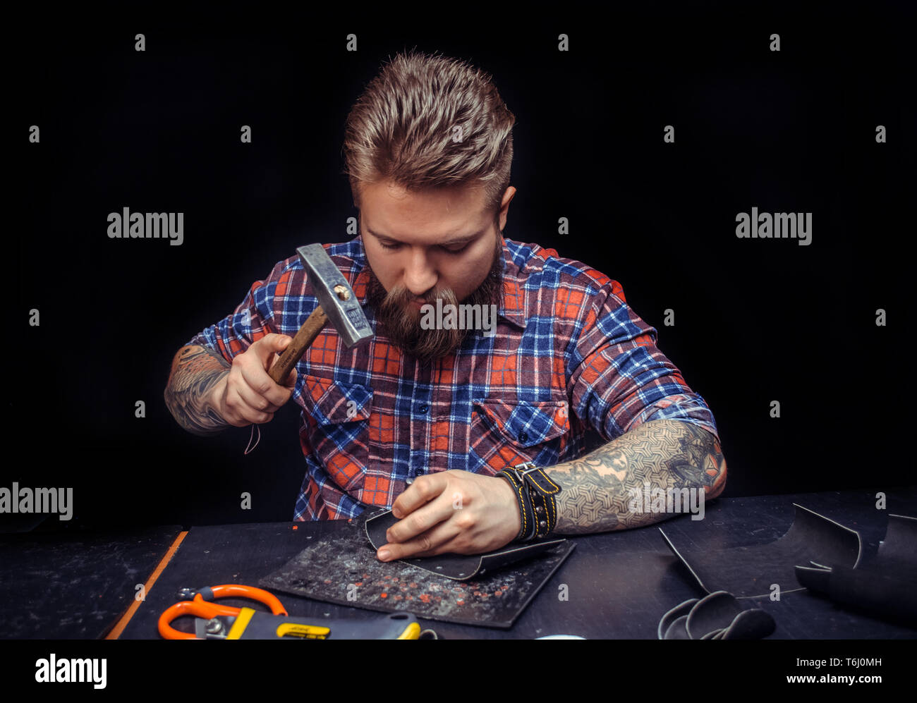 Professional Leather Worker producing leather workpiece Stock Photo