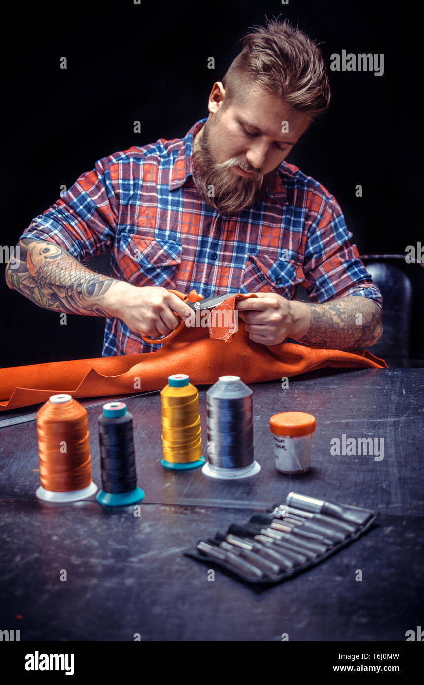 Leather Artist producing a leatherwork Stock Photo