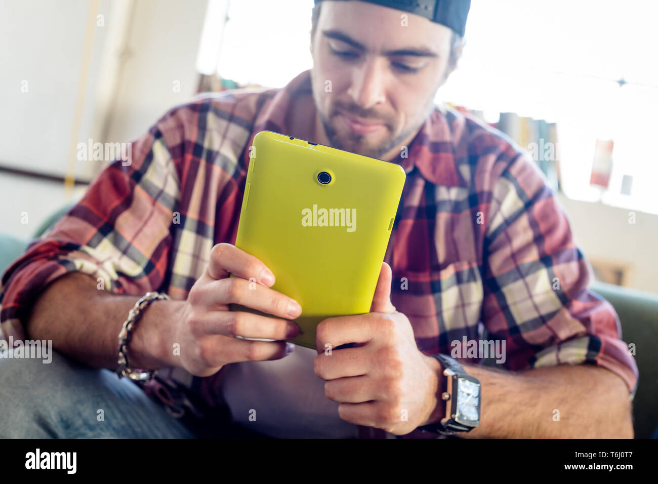 Person relaxing using a tablet at home Stock Photo