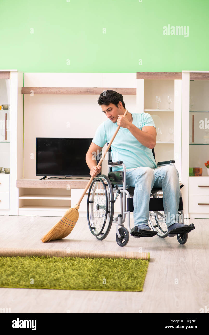 Disabled man on wheelchair cleaning house Stock Photo Alamy