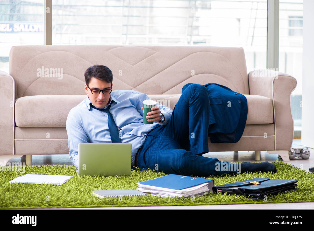 Businessman taking work home and working overtime Stock Photo