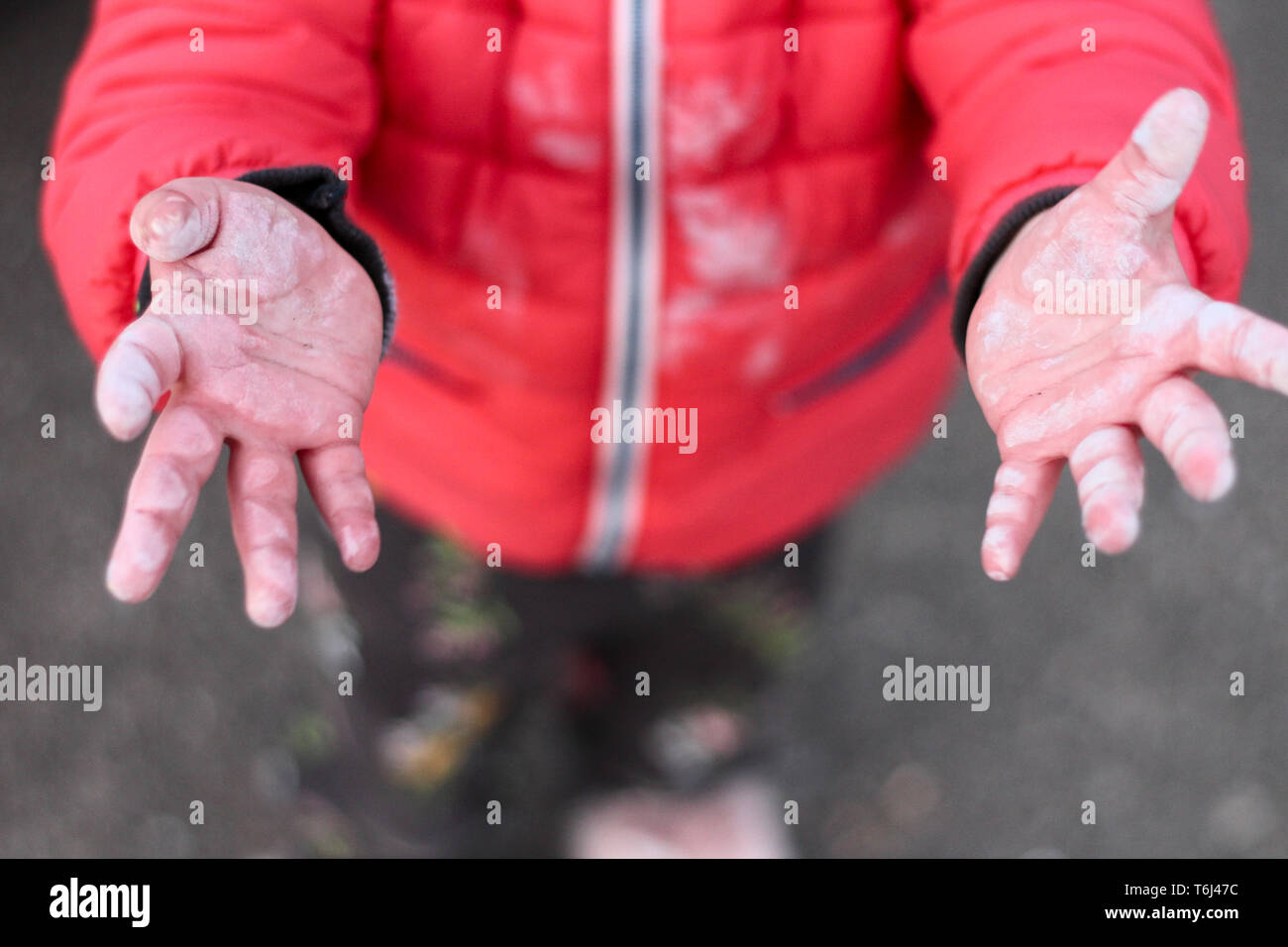 small children’s dirty hands arms outstretched to the top on the