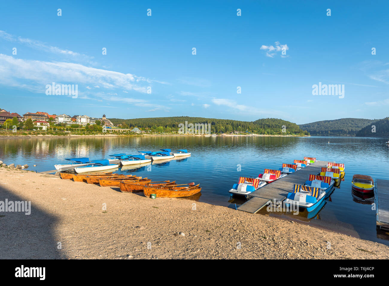 lake Schluchsee in the High Black forest and the town Schluchsee at sunset, Germany, landing stages with boats at the stage to rent, near St. Blasien  Stock Photo