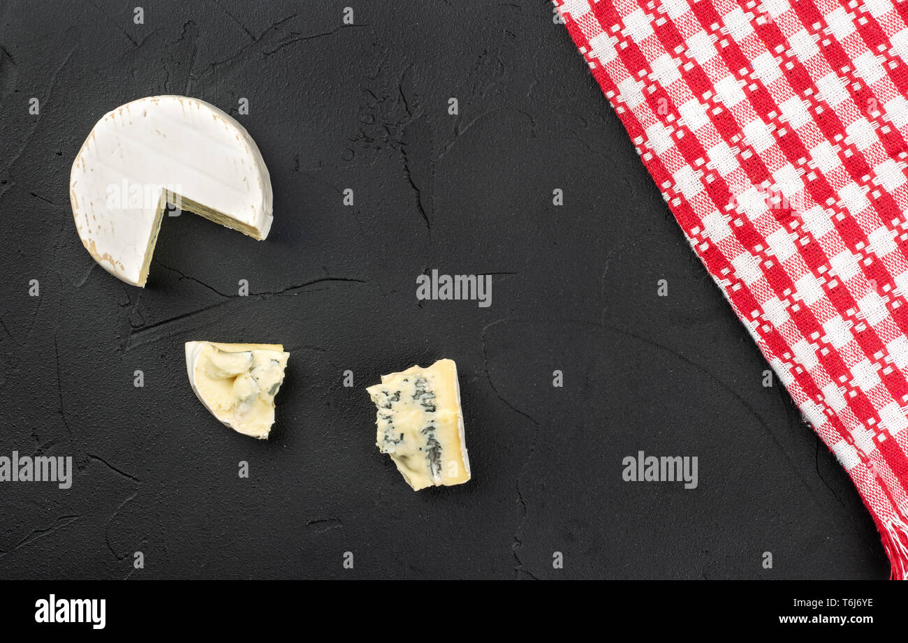 Brie cheese with two slices on concrete background, top view Stock Photo