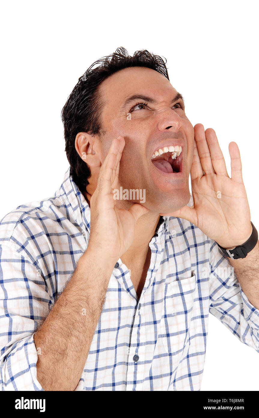 Caucasian man shouting with hands on mouth Stock Photo