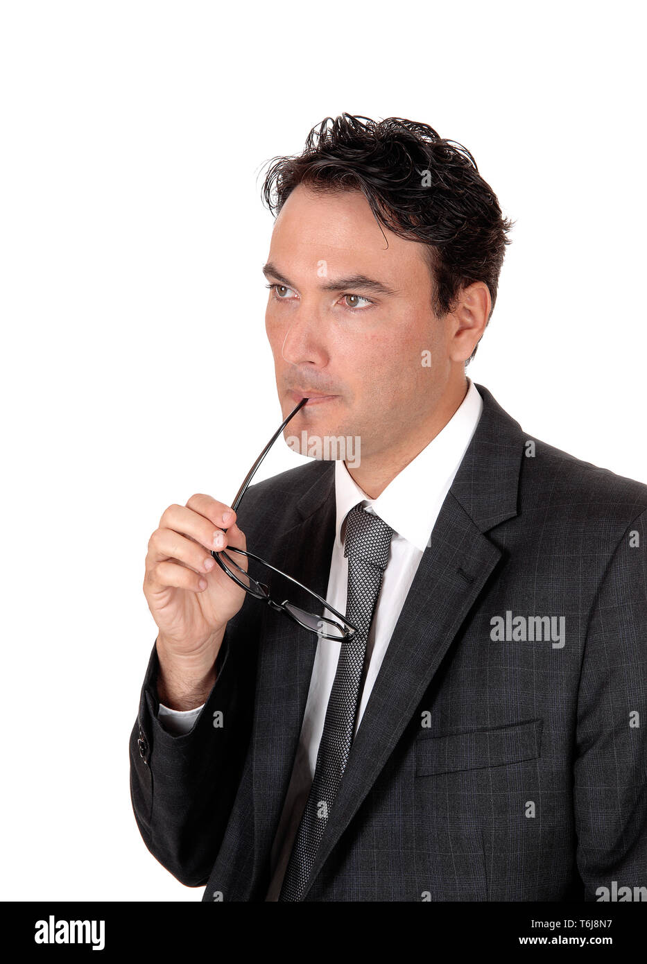 Businessman thinking with glasses in his mouths Stock Photo