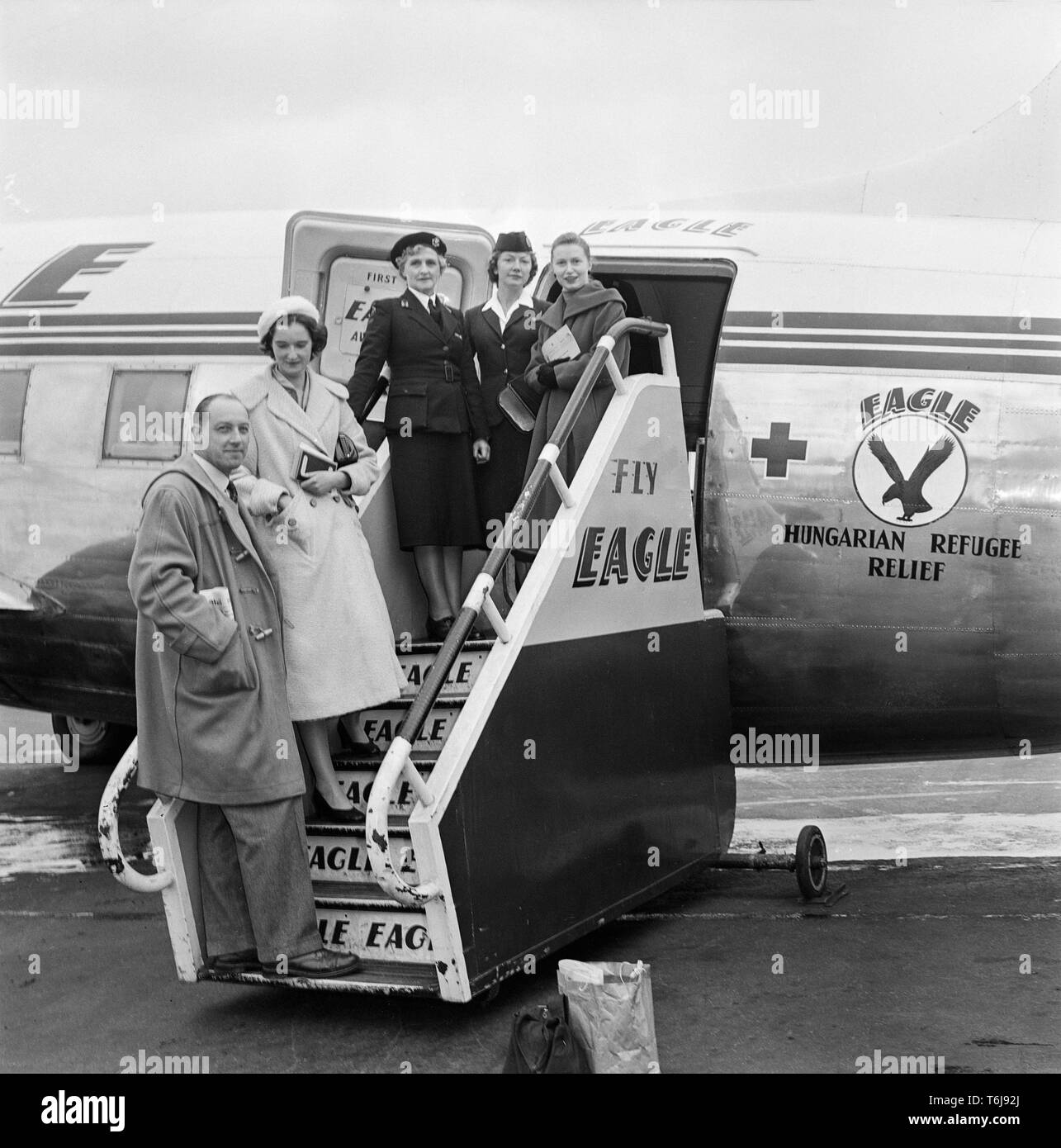 A Vickers Viking aeroplane belonging to the British airline Eagle Airways, bringing refugees from  Hungary to Britain. Photograph taken at Blackbushe Aerodrome in England in 1957. Stewardesses and other staff posing on the steps up to the aeroplane which has Hungarian Refugee Relief written on the side. Stock Photo