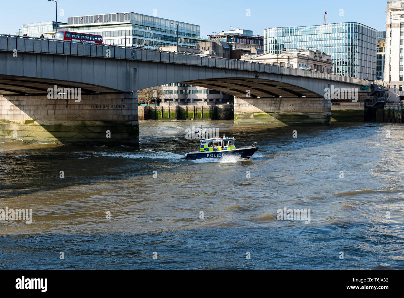 LONDON, UK - APRIL 1, 2019: The Marine Police Force (Thames River Police), Patrolling under London Bridge Stock Photo