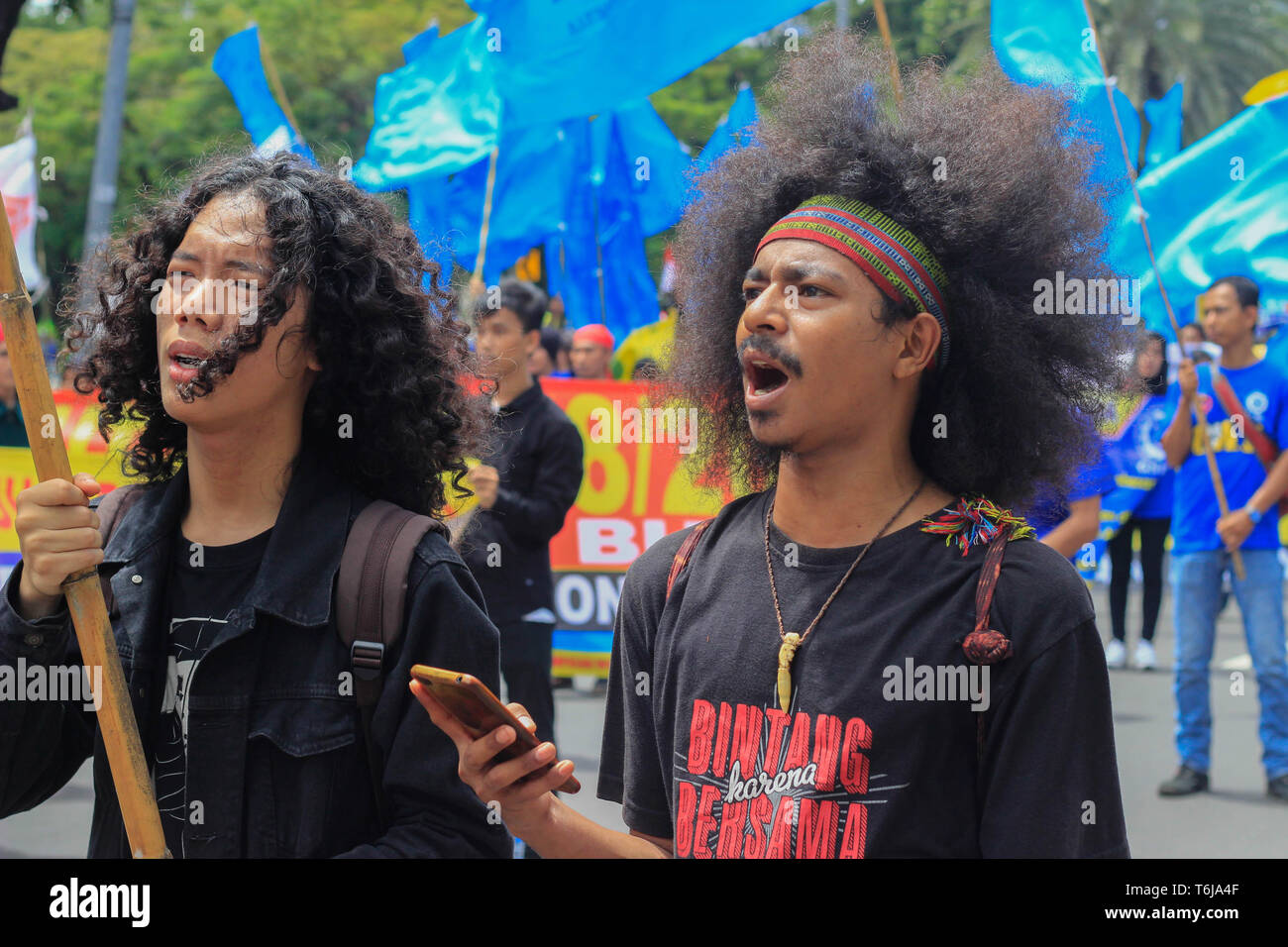 Indonesian workers chanting slogans during the rally. Thousands of workers are urging the government to raise minimum wages and to improve working conditions. Stock Photo