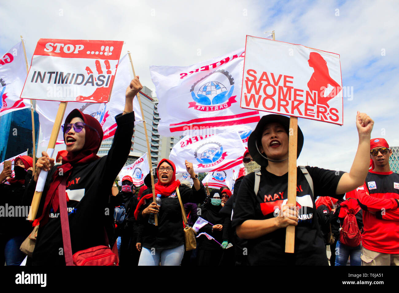 Workers are seen holding placards during the rally. Thousands of workers are urging the government to raise minimum wages and to improve working conditions. Stock Photo