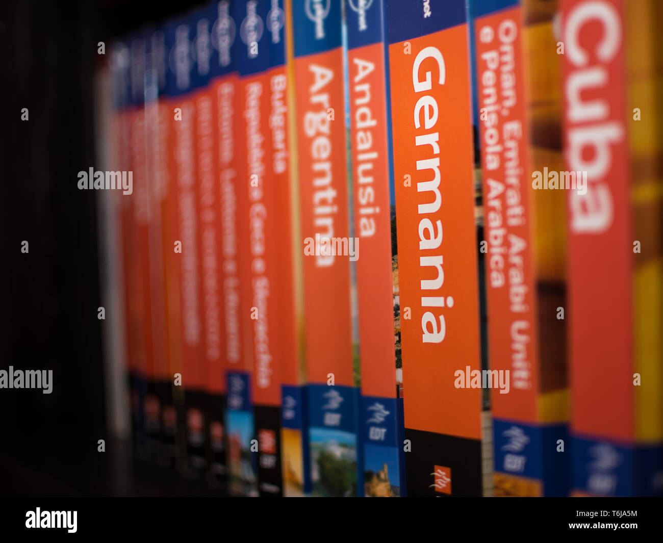 Chieti, Italy - April 4, 2019: Books of the Lonely Planet series on the bookcase with only the book of Germany in focus, with nobody Stock Photo