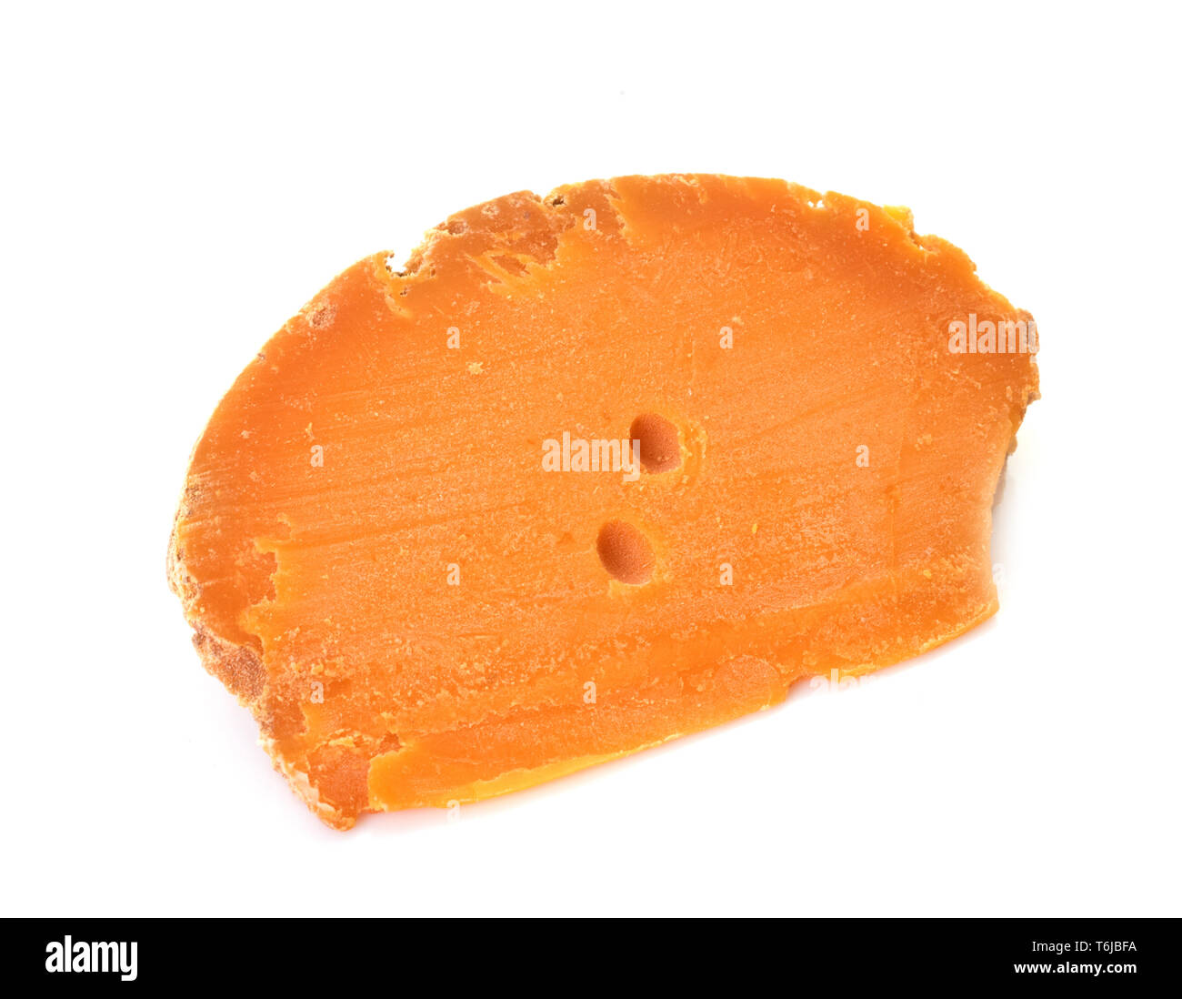 mimolette cheese in front of white background Stock Photo