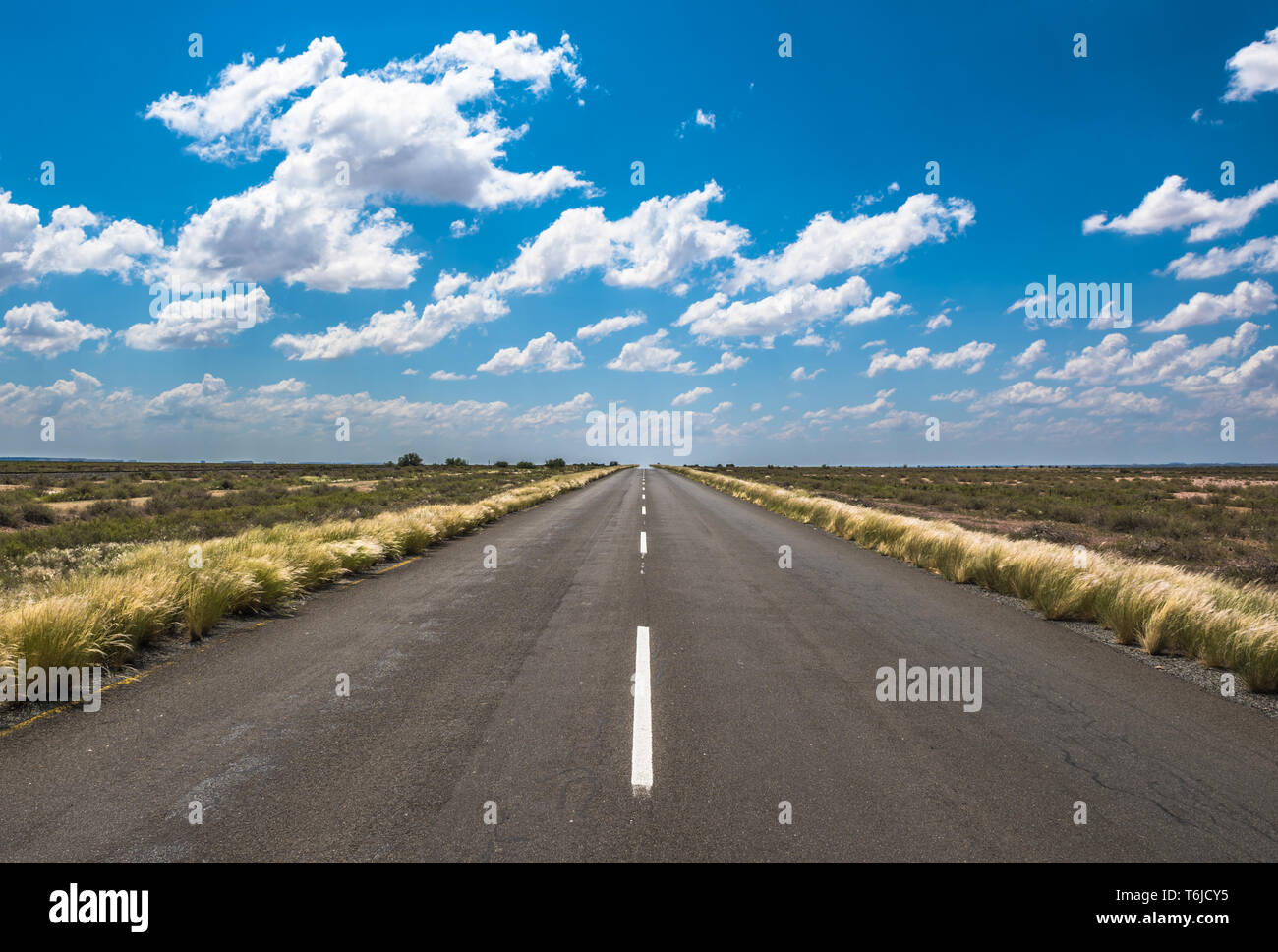 vibrant image of highway and blue cloudy sky Stock Photo - Alamy