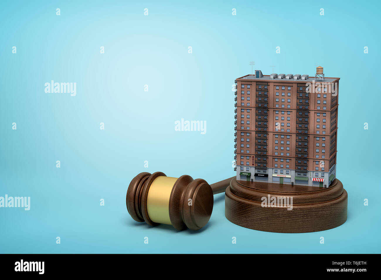 3d rendering of block of flats standing on sounding block with judge gavel lying beside on light-blue background. Stock Photo